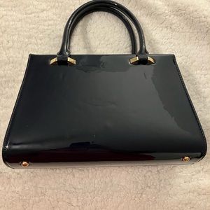 NWOT navy purse with adorable lining. Could be used as a crossbody as well.